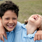Two boys laughing wearing blue shirts - hero image or Rapid Review Foster Care Recruitment and Retention April 2024