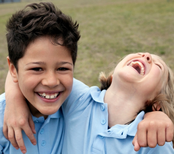 Two boys laughing wearing blue shirts - hero image or Rapid Review Foster Care Recruitment and Retention April 2024